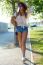 Beautiful Young Woman Walking With Her Dog In The Park