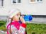 Girl Drinking Water From A Bottle On The Street In Autumn