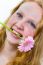 Face Of Girl With Pink Flower In Her Mouth