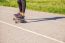 Young Woman Skateboarding In The Park