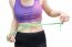 Woman In Sport Bra Measuring Her Body With Tape Isolated On Whit