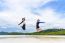 Two Asian Teen Girls Friends Jumping Enjoy On The Beach