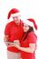 Christmas Couple Looking A Tablet Computer