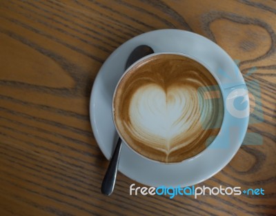 A Cup Of Coffee With Heart Pattern In A White Cup Stock Photo