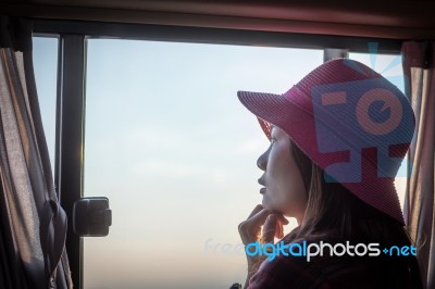 A Girl Wearing A Hat Sitting In A Bus Was Watching The View Thro… Stock Photo