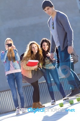 A Group Of Friends Having Fun With Skate In The Street Stock Photo