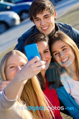 A Group Of Friends Taking Photos With A Smartphone Stock Photo