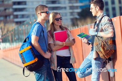 A Group Of Friends Talking In The Street After Class Stock Photo