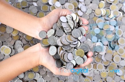 A Lot Of Coins In Hands Stock Photo