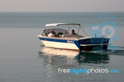 A Motorboat Slowing Cruising On Lake Garda Stock Photo