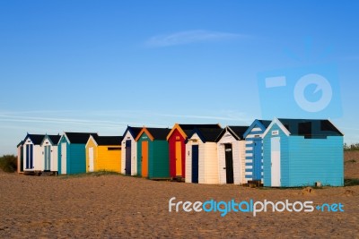 A Row Of Brightly Coloured Beach Huts In Southwold Stock Photo