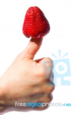 A Strawberry Stuck In Thumb Stock Photo