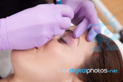 A Woman Getting Permanent Make Up Stock Photo