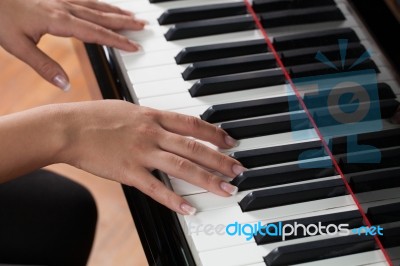 A Woman Playing Piano Stock Photo