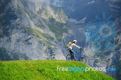A Woman Ready To Go Down From Hill By Kick Scooter At Bort Stati… Stock Photo