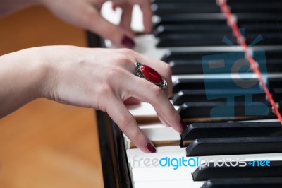 A Woman With Red Ring Playing Piano Stock Photo A Woman With Red Ring Playing Piano Stock Photo