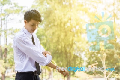 A Young Businessman Is Folding A White Sleeve On His Balcony Stock Photo