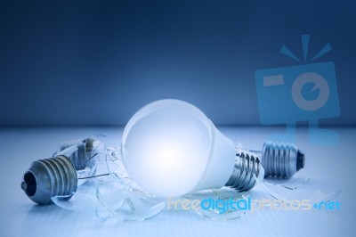 Abstract Of Led Light Bulb Glowing And Lyinjg With Another Broke… Stock Photo
