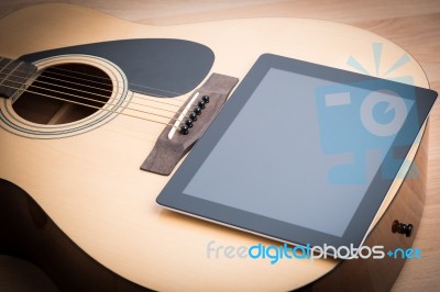 Acoustic Guitar With Digital Tablet Stock Photo