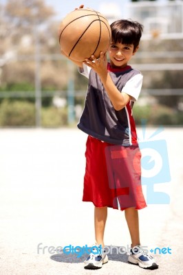 Adorable Boy With Basketball Stock Photo