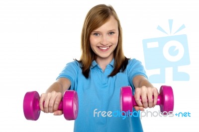 Adorable Teen Holding Dumbbells In Her Outstretched Arms Stock Photo