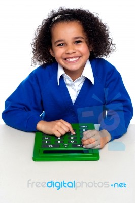 African Elementary School Kid Using A Calculator Stock Photo