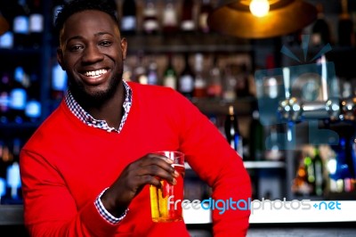 African Guy Posing With Chilled Beer Stock Photo