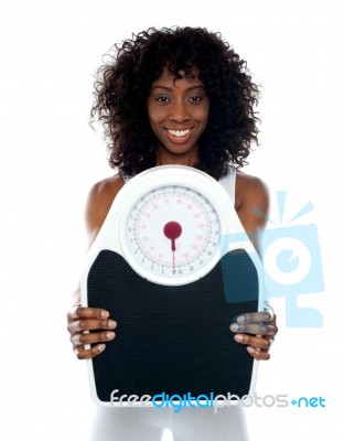 African Lady Showing Weighing Scale Stock Photo