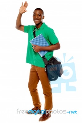 African Male Holding Book And Bag Stock Photo