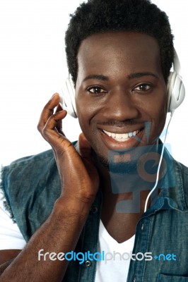 African Man Listening To Music Stock Photo
