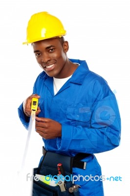 African Repairman Holding Tape Stock Photo