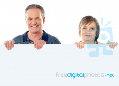 Aged Couple Holding Blank Board Stock Photo