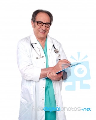 Aged Doctor Holding Clipboard Stock Photo