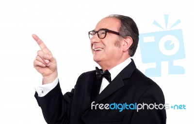 Aged Man Looking And Indicating Up Stock Photo