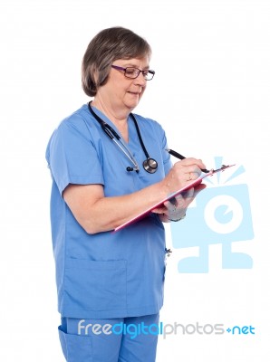 aged surgeon Writing Report Stock Photo aged surgeon Writing Report Stock Photo