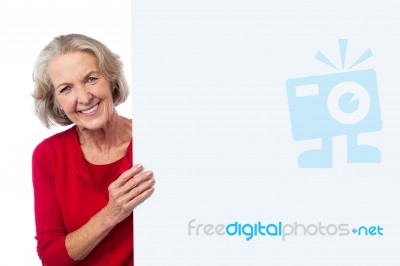 Aged Woman Holding Blank Ad Board Stock Photo