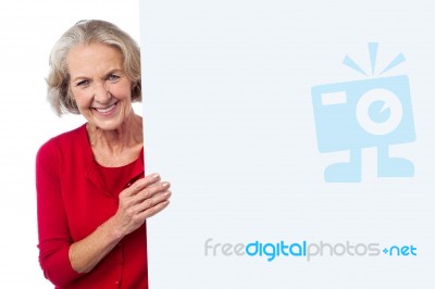 Aged Woman Holding Blank Ad Board Stock Photo