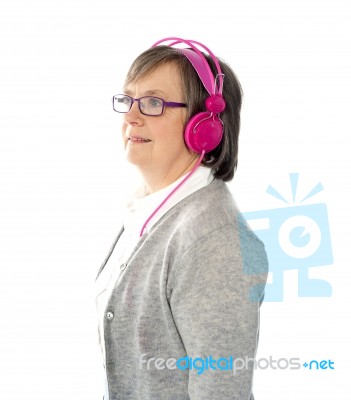 Aged Woman Wearing Headphone Stock Photo