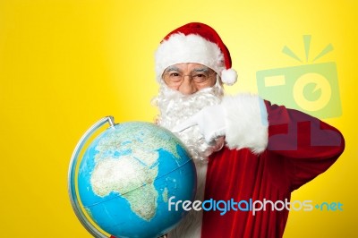 Ages Man In Santa Costume Holding Globe Stock Photo
