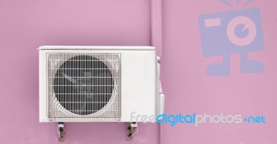 Air Compressor On Pink Wall Stock Photo