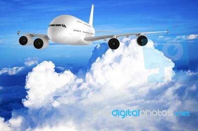 Airplane Flying In The Blue Sky Stock Photo