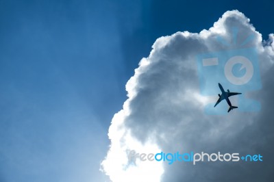 Airplane In The Clouds Stock Photo