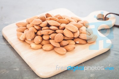 Almond Nuts On Wooden Plate Stock Photo