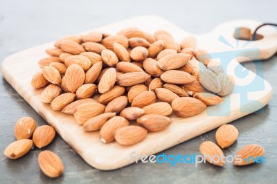 Almond Nuts On Wooden Plate Stock Photo