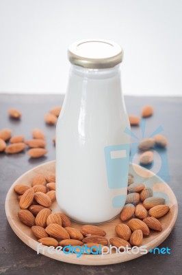 Almond Nuts On Wooden Plate With Milk Stock Photo