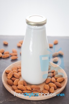 Almond Nuts On Wooden Plate With Milk Stock Photo Almond Nuts On Wooden Plate With Milk Stock Photo