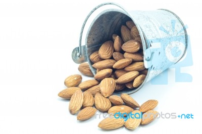 Almonds In Bucket Isolated On White Background Stock Photo