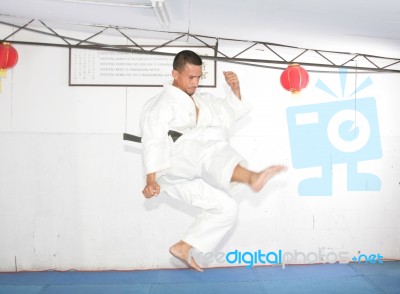 American Man In Karate Suit, Suspended In Mid Air Stock Photo American Man In Karate Suit, Suspended In Mid Air Stock Photo