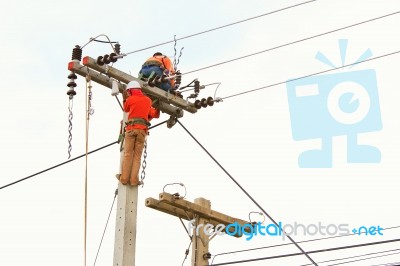 An Electrical Power Utility Worker In A Bucket Fixes The Power Line Stock Photo