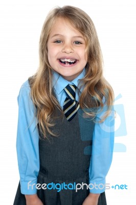 An Excited School Girl In Uniform Wearing Braces Stock Photo